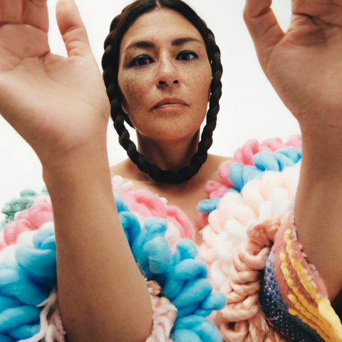 A woman in a multi coloured dress