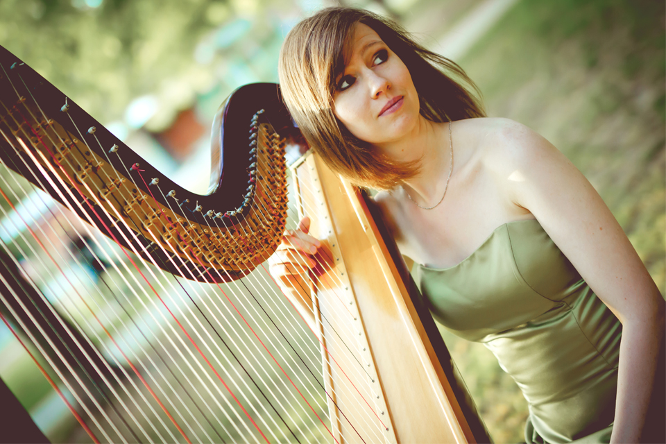 Kristan Toczko standing with her Harp