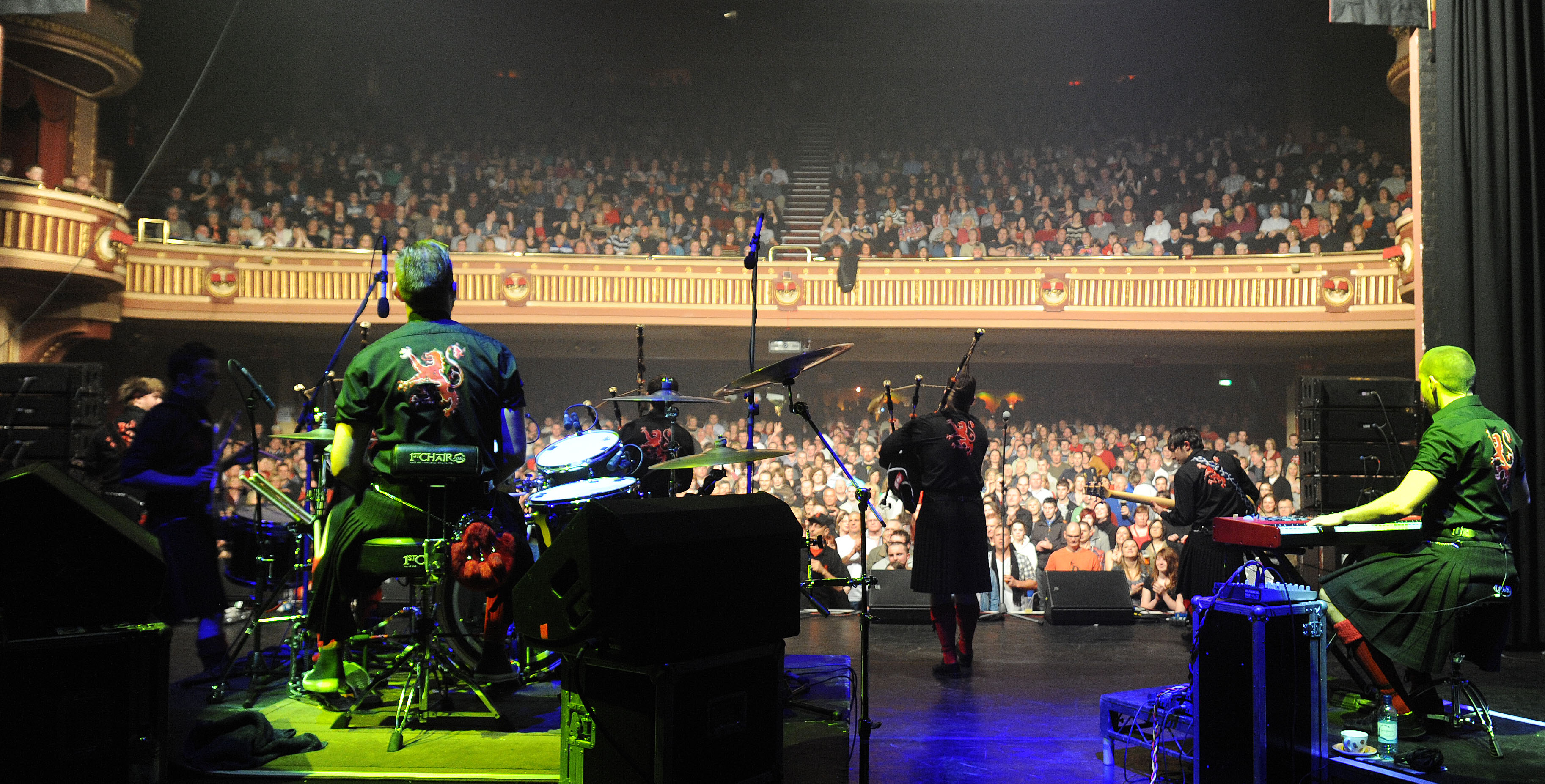 A group of bag pipe performing on a stage