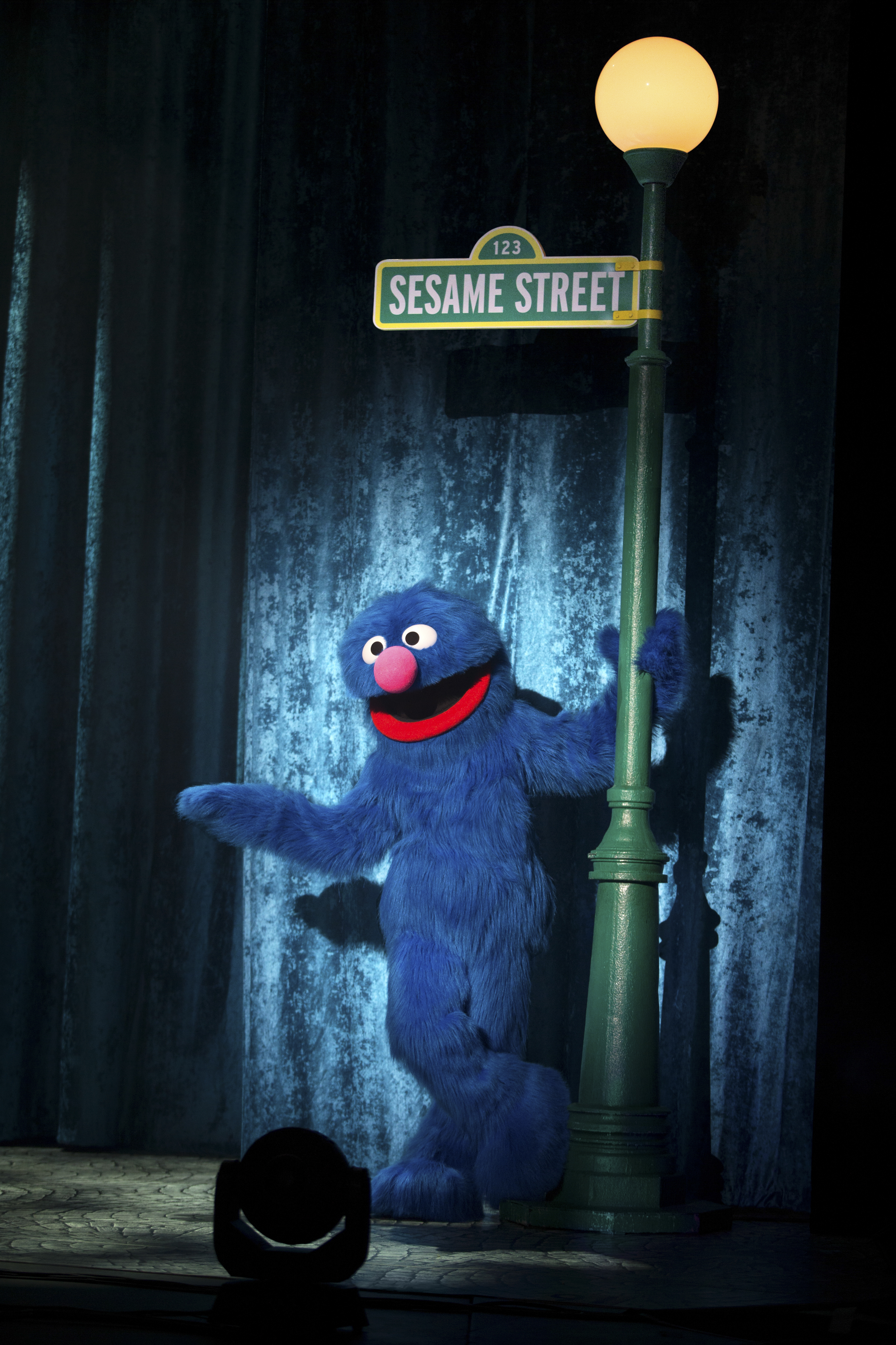 Grover standing under a street lamp