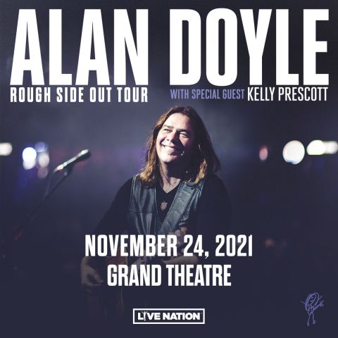 Alan Doyle with guitar on stage