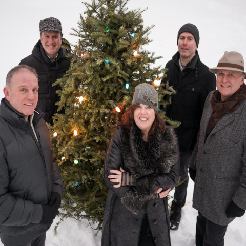 The Barra MacNeils with a Christmas Tree in the snow