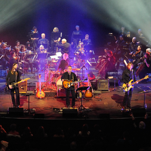 Full band and orchestra on stage.