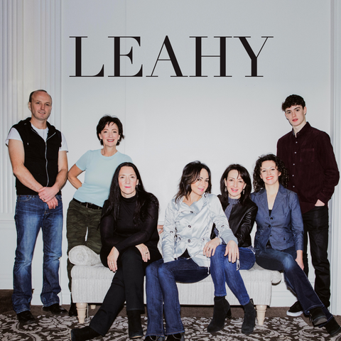 Leahy family in blue jeans in front of a white wall