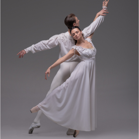 A male and female dancer both dressed in white.