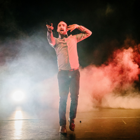 Paul O'Donnell posing in front of smoke and lights. 