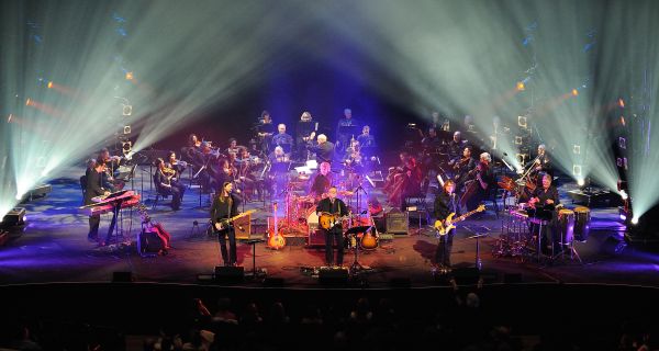 Full band and orchestra on stage.