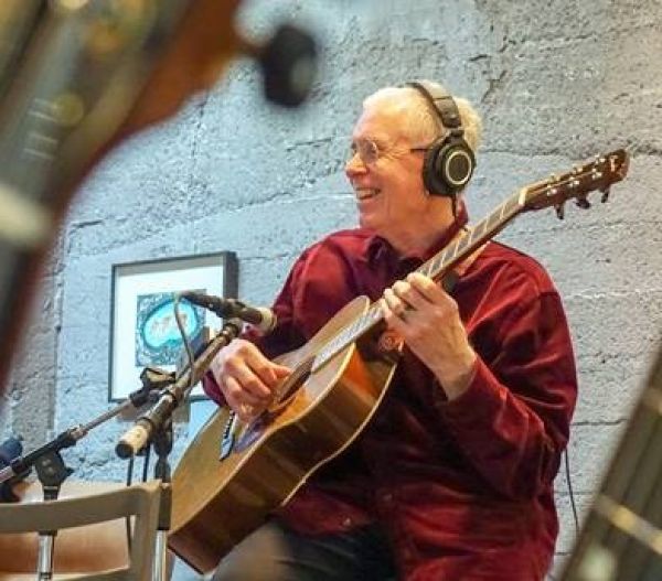 Bruce Cockburn playing guitar