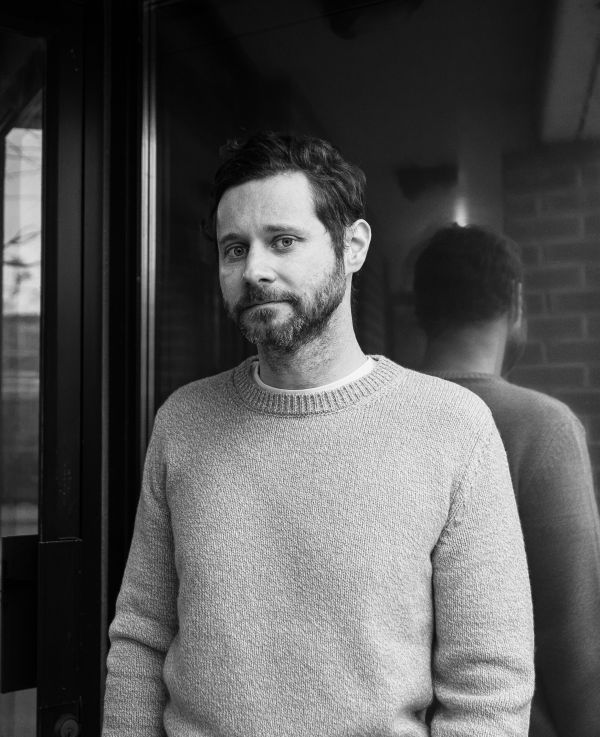 Dan Mangan with reflection behind him, photo credit to Jonah Atkins