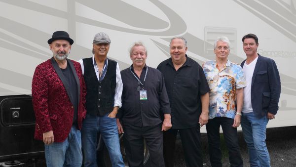 members of Downchild Blues band standing infront of their tour bus