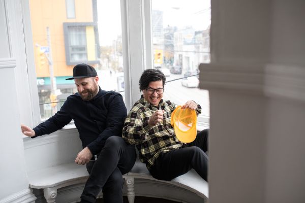 members of CCC, seated together in a window sill, laughing out loud