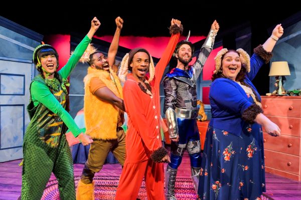 Five people dancing on stage dressed as characters from the book in colourful costumes