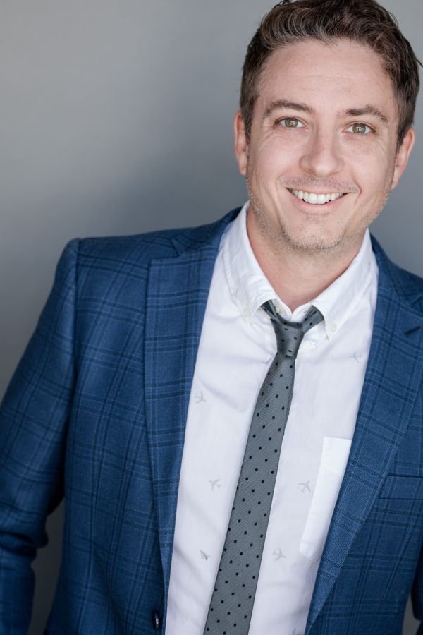 white man in a blue suit with blue tie