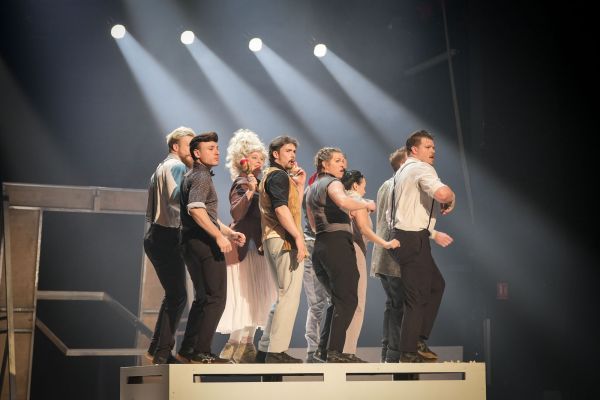 Dancers performing on a stage.