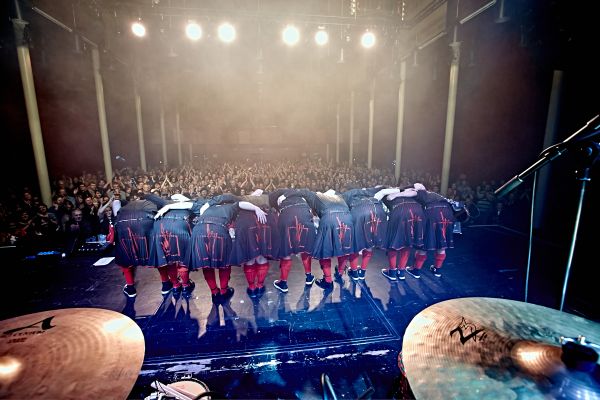 A group of bag pipe performing on a stage